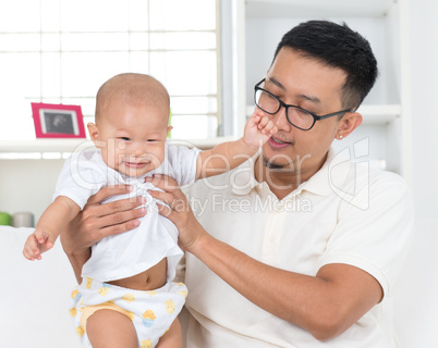 father playing with his baby boy.