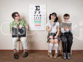 Three person wearing spectacles in an office at the doctor