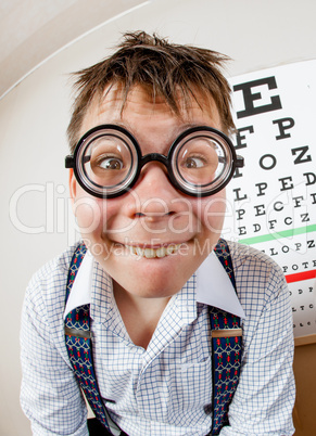 Funny boy wearing spectacles in an office at the doctor