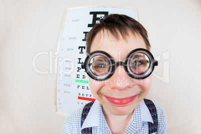 funny boy wearing spectacles in an office at the doctor