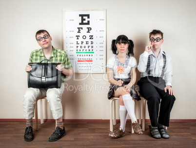 three person wearing spectacles in an office at the doctor