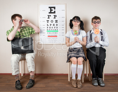 three person wearing spectacles in an office at the doctor