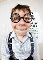 funny boy wearing spectacles in an office at the doctor