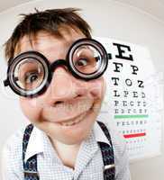 funny boy wearing spectacles in an office at the doctor