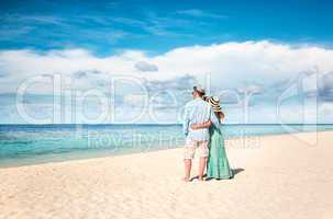 Vacation Couple walking on tropical beach Maldives.