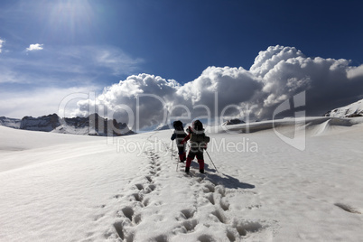 Two hikers on snowy plateau