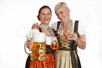 Two bavarian girls with beer in traditional costumes