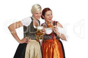 Two bavarian girls with beer in traditional costumes