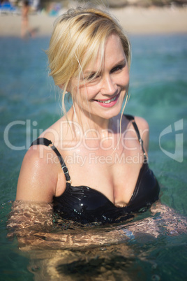 beautiful blonde woman swimming in the ocean