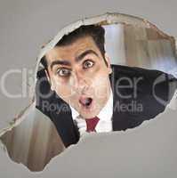 Man looking through a hole in the ceiling