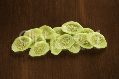 Sliced cucumber on wood