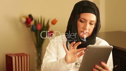 muslim doctor working with digital tablet