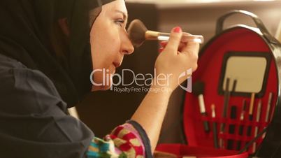 Muslim woman applying  make up