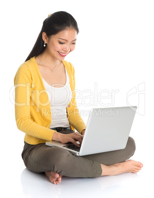 asian girl typing on laptop