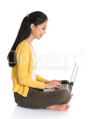 side view asian girl using notebook computer