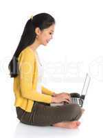 side view asian girl using notebook computer