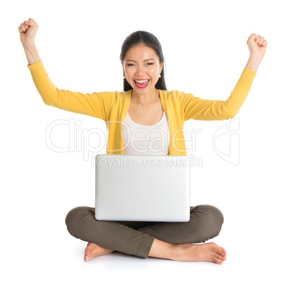 asian girl arms up using laptop computer