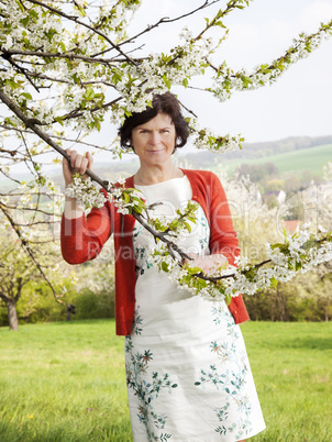 Woman is recovering under blooming cherry tree old