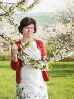 Woman is recovering under blooming cherry tree old