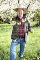 Man enjoys the great outdoors under blooming cherry tree