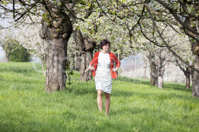 Woman is recovering under blooming cherry tree old