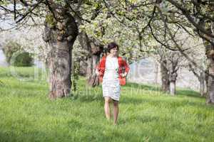 Woman is recovering under blooming cherry tree old