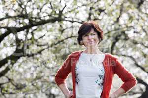 Portrait of women among blooming old cherry tree