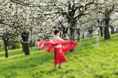 Woman with red cloth with cherry blossom