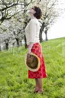 Woman with straw hat with cherry blossom