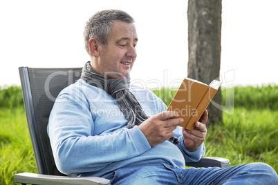Man reading in the book in nature