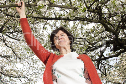 Woman is recovering under blooming cherry tree old