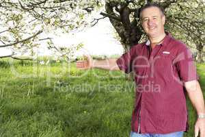 Man with hands under blooming cherry tree