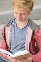Teenage boy studying reading book