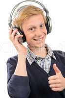 Happy teenage boy with headphones thumb-up