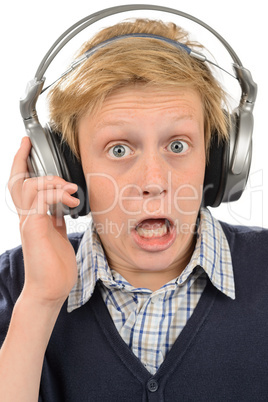 Shocked teenage boy listening to music