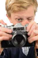 Teenage boy photographing through retro camera