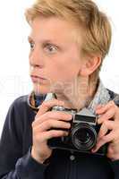 Shocked teenage boy holding retro camera