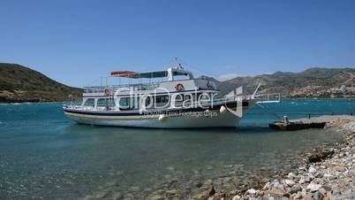 The traditional Greek motor yacht for tourists transportation at Spinalonga island, Crete, Greece