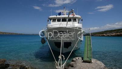 The traditional Greek motor yacht for tourists transportation is near beach, Crete, Greece