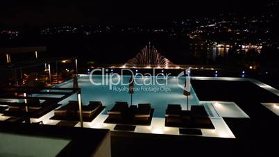 Swimming pool with fountain in night illumination at the luxury hotel, Crete, Greece