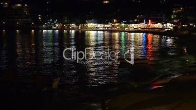 The traditional Greek boats for fishing and shore in night illumination, Crete, Greece