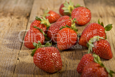 close up of strawberries on wood