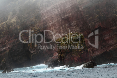 Over 600 million years old rocks on Newfoundland coast line in fogy day