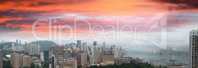 Sunset sky over Hong Kong bay. Aerial view of city skyscrapers