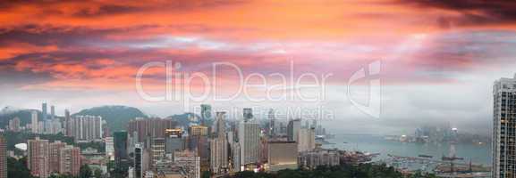 Sunset sky over Hong Kong bay. Aerial view of city skyscrapers