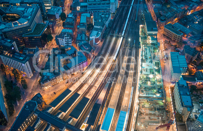 London. Train station and Tower Bridge night lights, aerial view