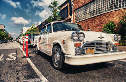 BROOKLYN - JUN 11, 2013: Vintage white taxi cabs await customers