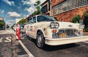 BROOKLYN - JUN 11, 2013: Vintage white taxi cabs await customers