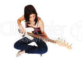 Sitting woman playing guitar.