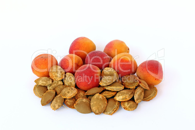 Apricots and apricot kernels, on white background